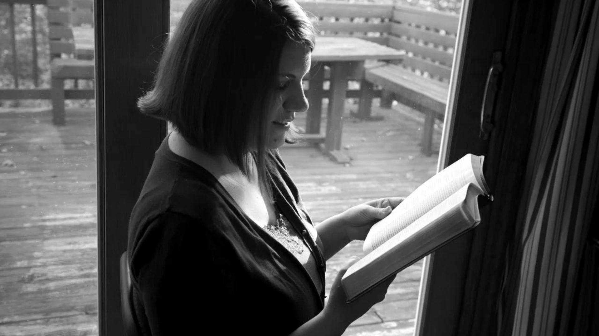 a lady reading a bible showing the role of religion in coping with stress